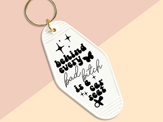 Behind every bad bitch is a car seat - Motel keychain