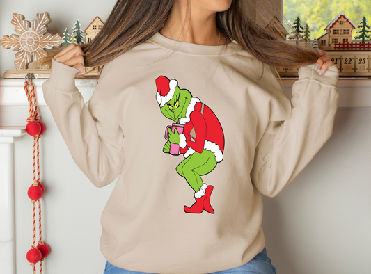 Grinch in Santa suit with iced coffee - sneaking