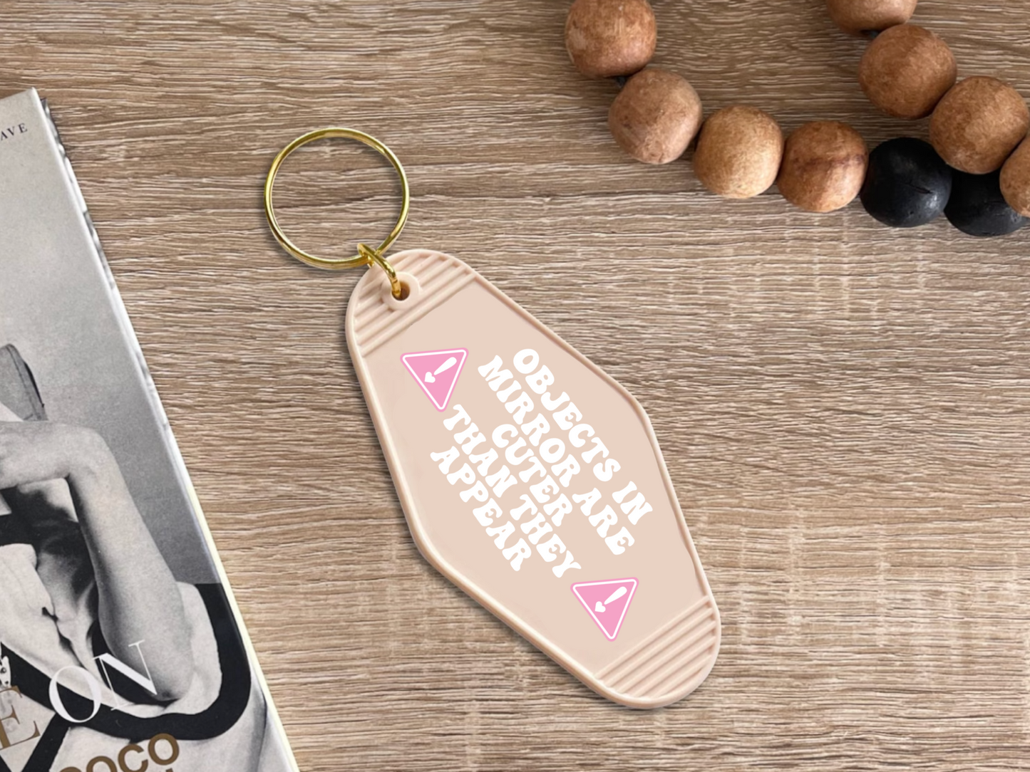 Objects in mirror are cuter than they appear - Motel keychain